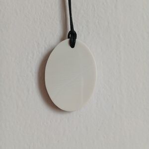 A mammoth tusk pendant in a hornbeam wood frame.